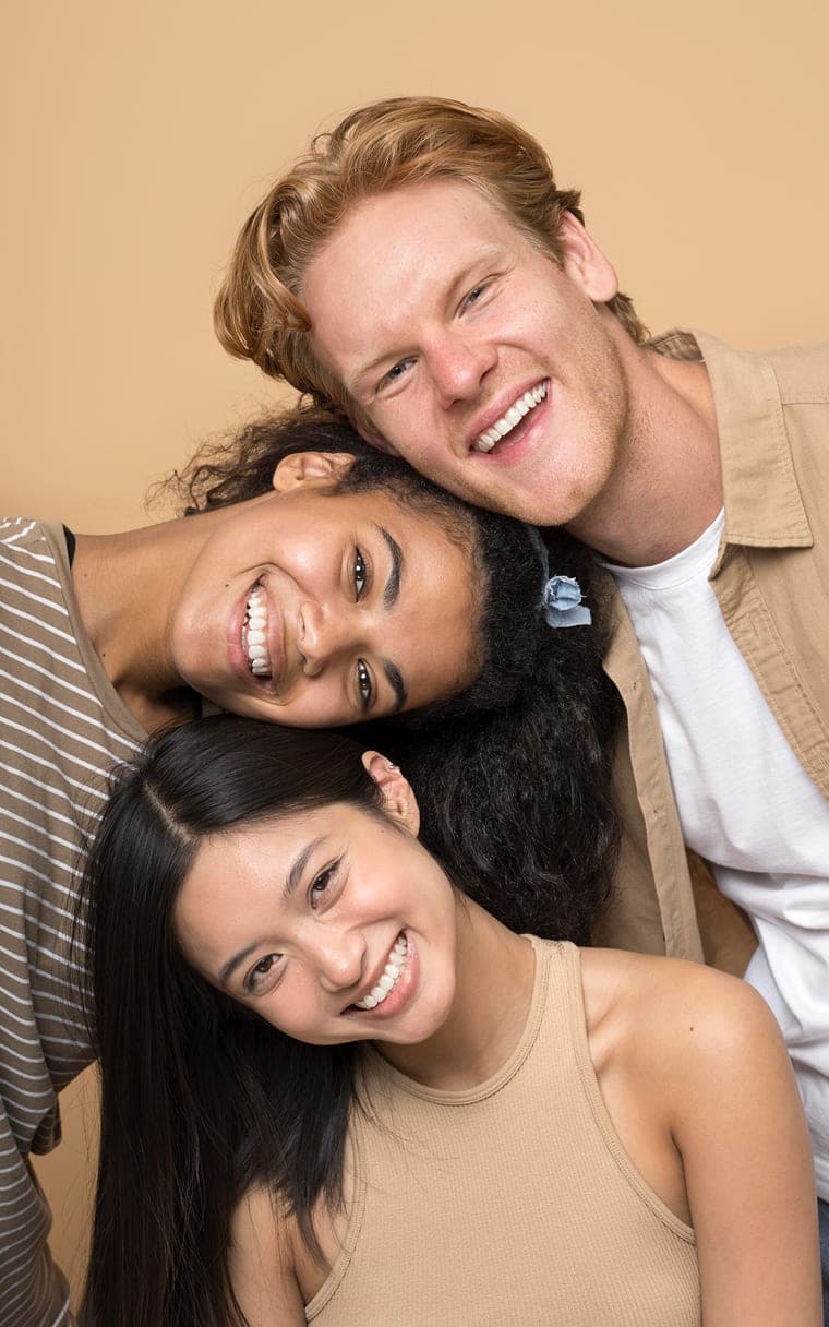Three people smiling together
